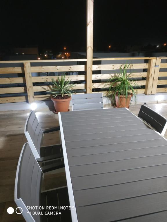 a table and chairs on a deck at night at אלת המדברGoddess of the desert in Beʼer Ora