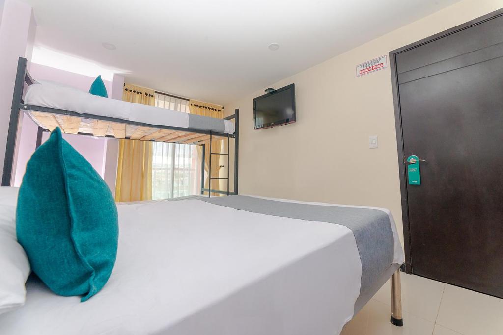 Postel nebo postele na pokoji v ubytování Ayenda Balcon Real