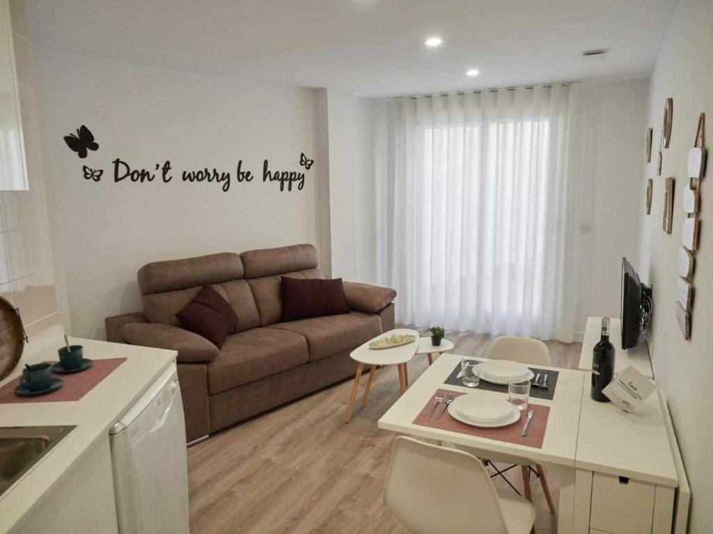 a living room with a couch and a table at San José Apartamentos Turísticos Miky in Albacete