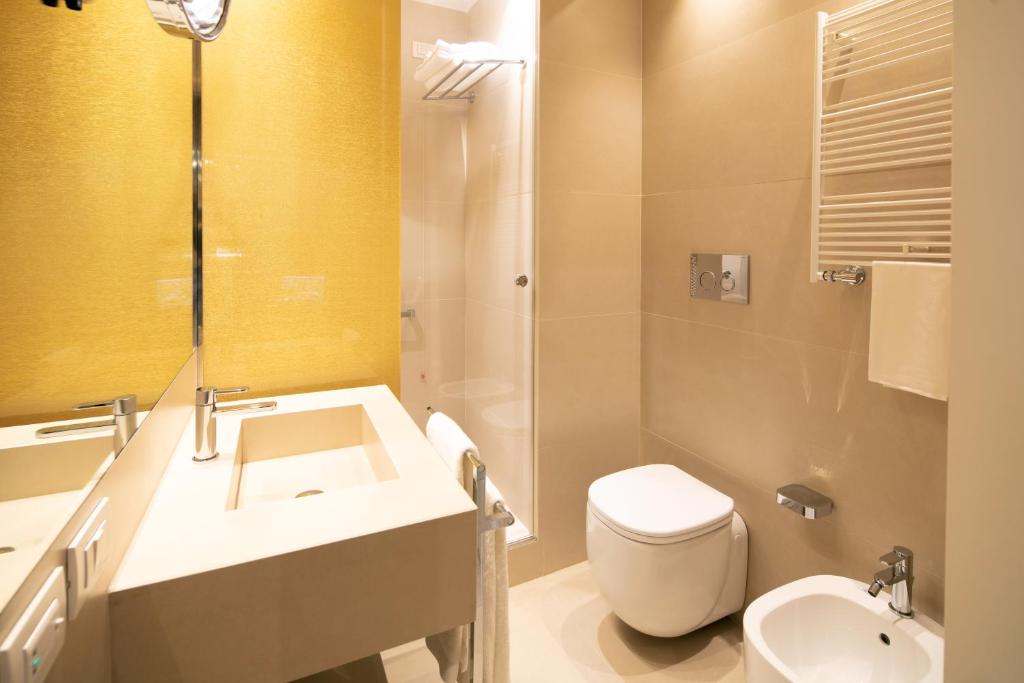 a bathroom with a white toilet and a sink at Palazzo Barocci in Venice