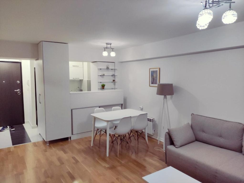 a living room with a couch and a table at Feels like home 3 in Skopje