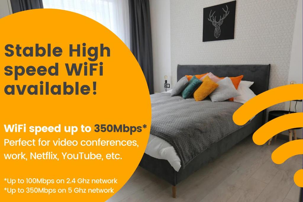 a bedroom with a bed with a yellow sign that reads stable high speed wifi available at Comfy 2 Room Apartment - Free Parking - 350Mbps WiFi - Netflix in Kaunas