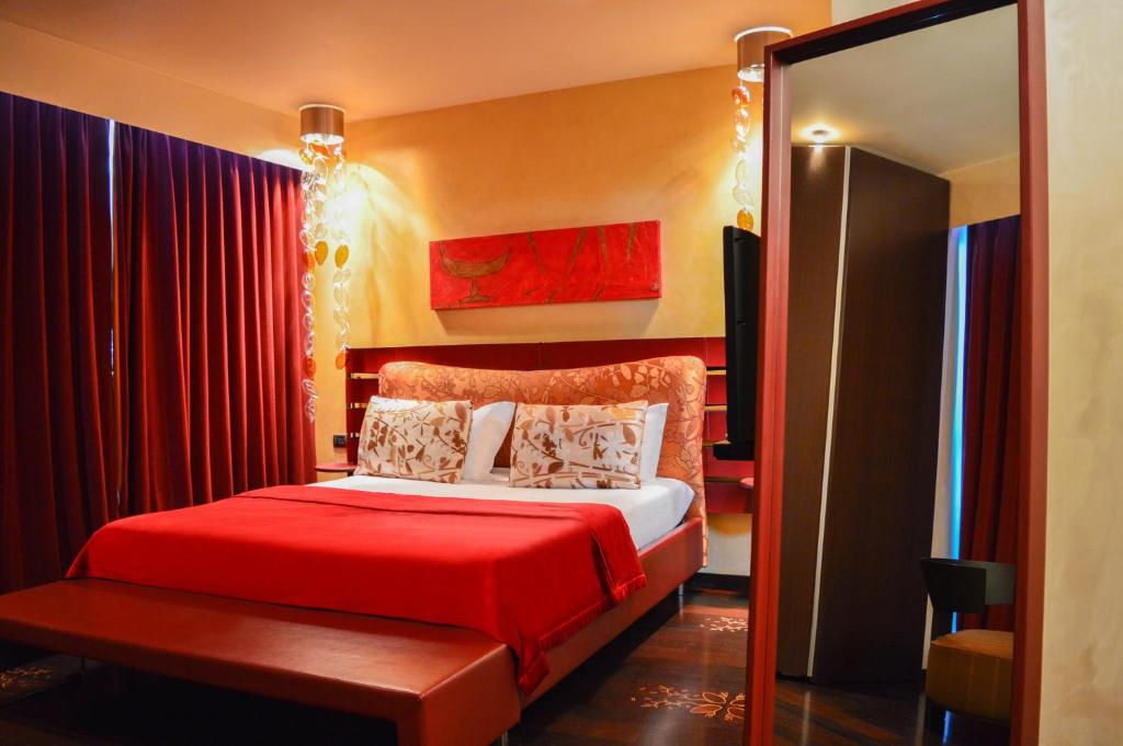 a bedroom with a red bed with a red blanket at Les Fleurs Boutique Hotel in Sofia
