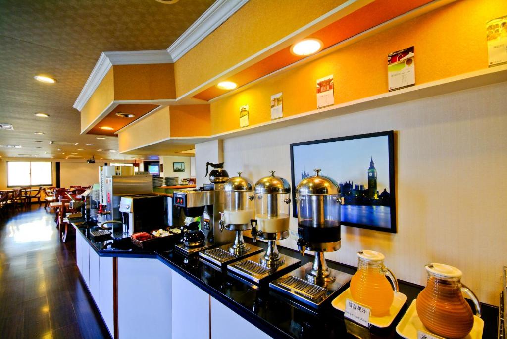 a bar in a restaurant with a counter with bottles at F Hotel Tainan in Tainan