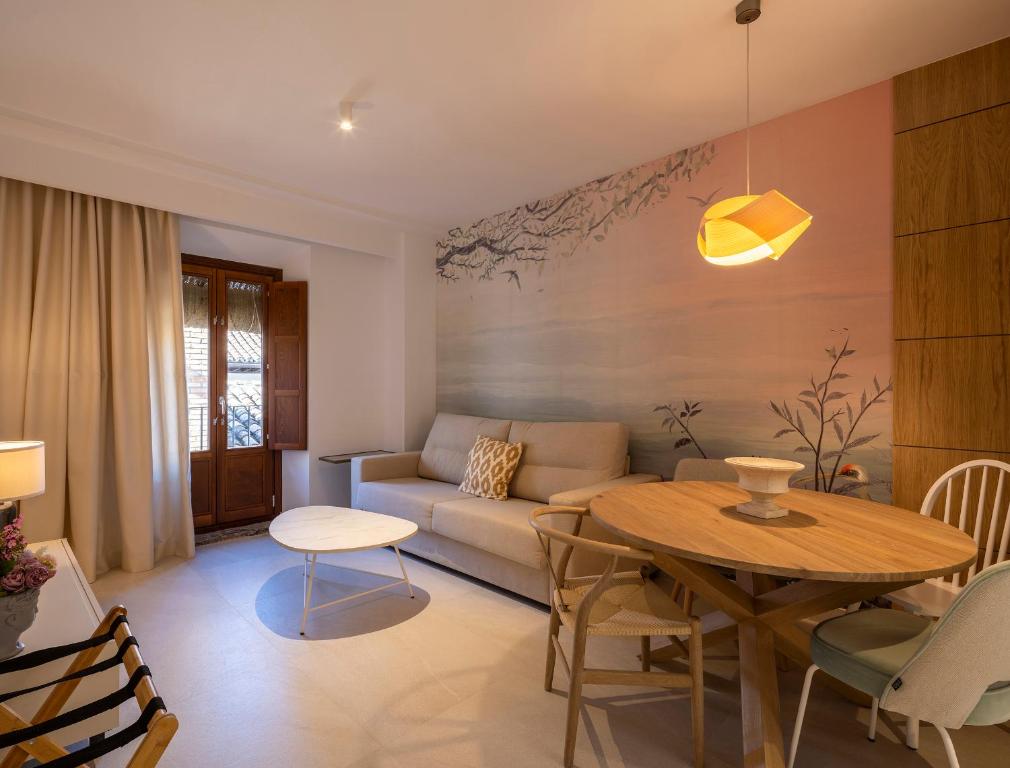 a living room with a couch and a table at CALM SUITES Molino Corteza del Carmen in Granada
