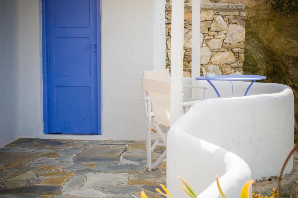 a blue door and a table and a chair at Κymanemi Folegandros in Agali
