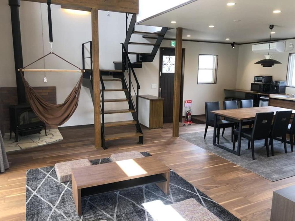a living room with a spiral staircase and a table at Kikuya Cottage - Vacation STAY 92195v in Yamanakako