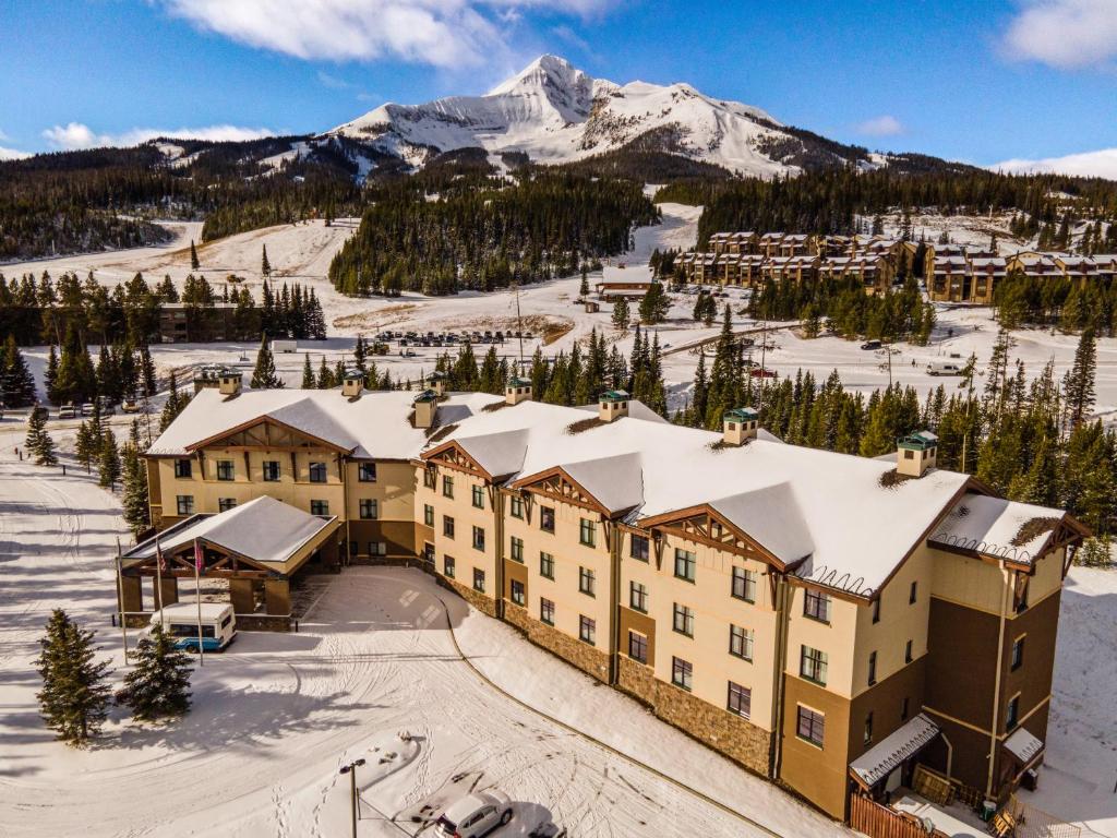 an aerial view of a resort with a snow covered mountain at The Lodge at Big Sky in Big Sky