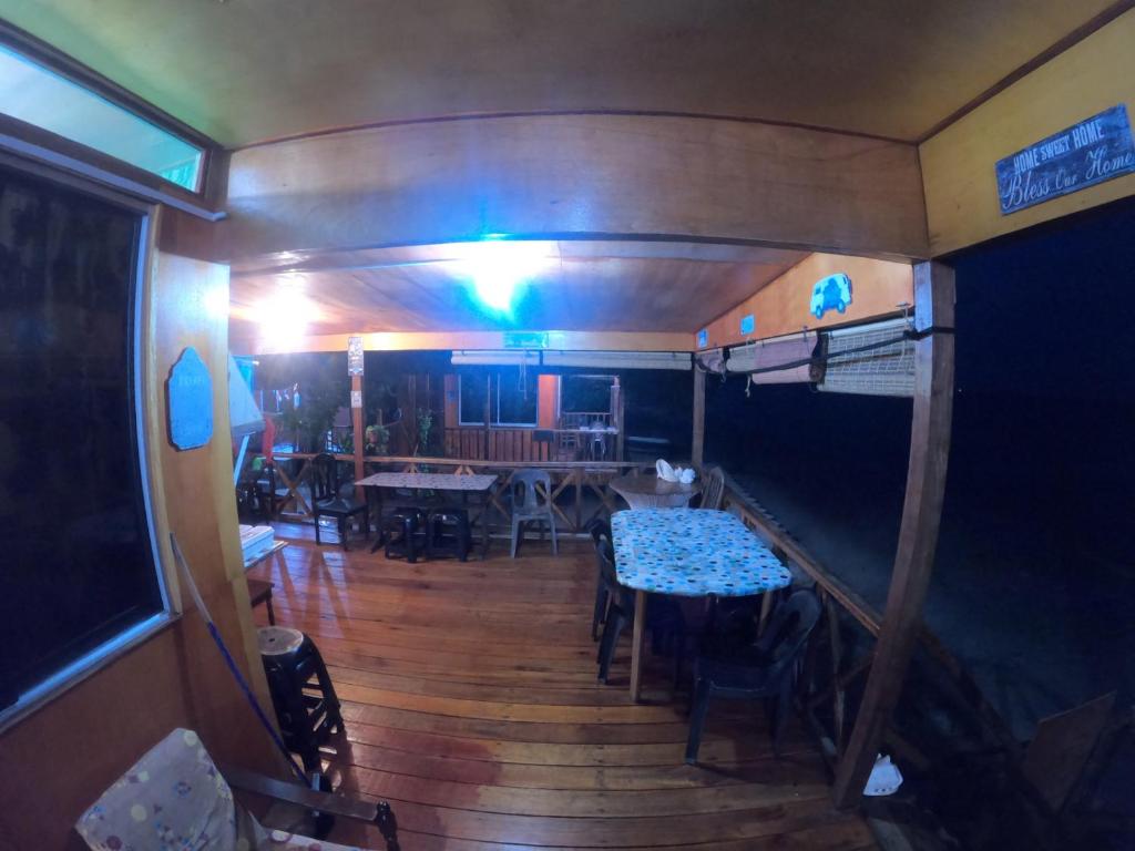 a dining room with a table and chairs in a trailer at Tajau Laut Guesthouse in Kudat