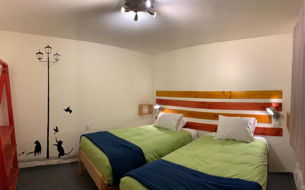 A bed or beds in a room at Gaia House Hostel