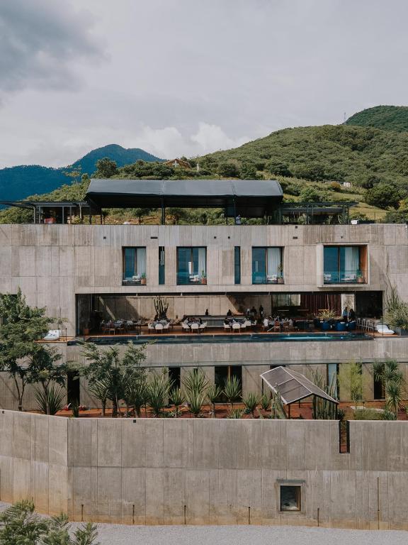 a building in front of a mountain at Flavia Hotel in Oaxaca City