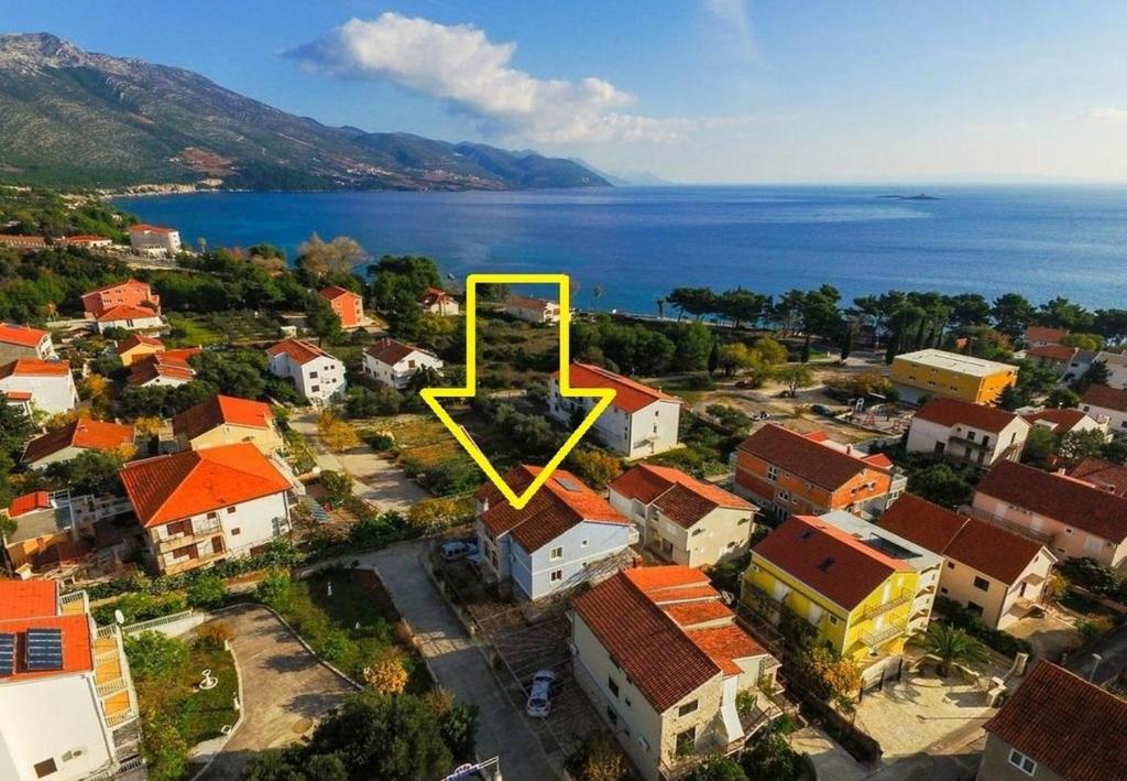 an aerial view of a town with a yellow arrow at Apartments Jaki - 150 m from beach in Orebić