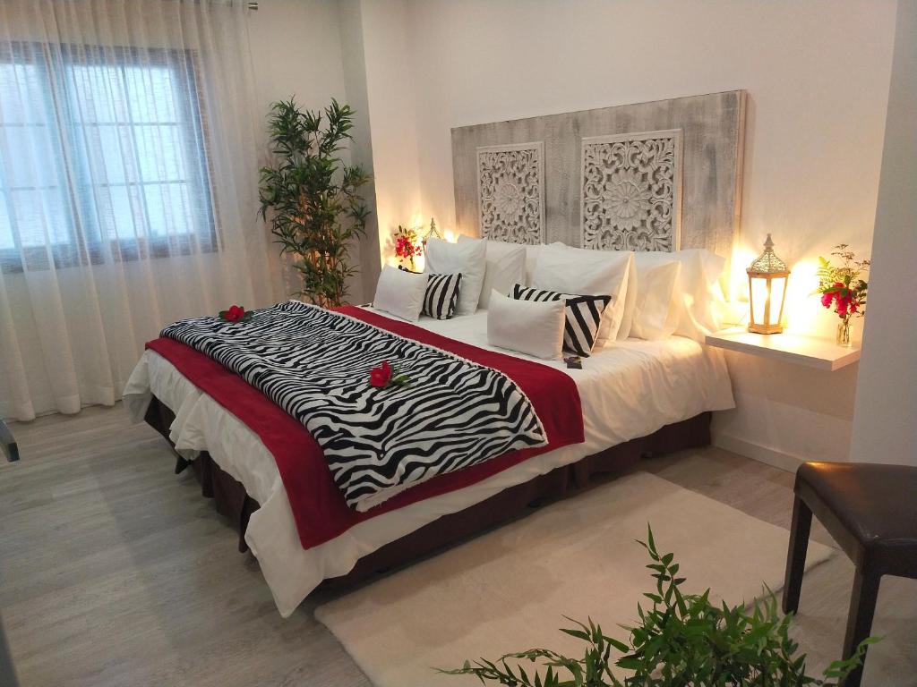 a bedroom with a zebra print bed with roses on it at Room Plaza & Parking in Icod de los Vinos