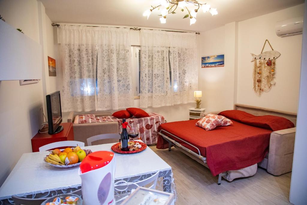 蒂勒尼亞的住宿－La Marea Monolocale sul mare，客厅配有床和水果桌