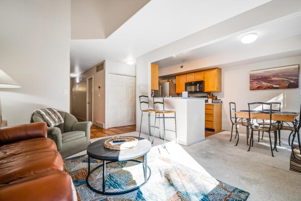 a living room with a couch and a table at Canyon Wind Casita in Moab