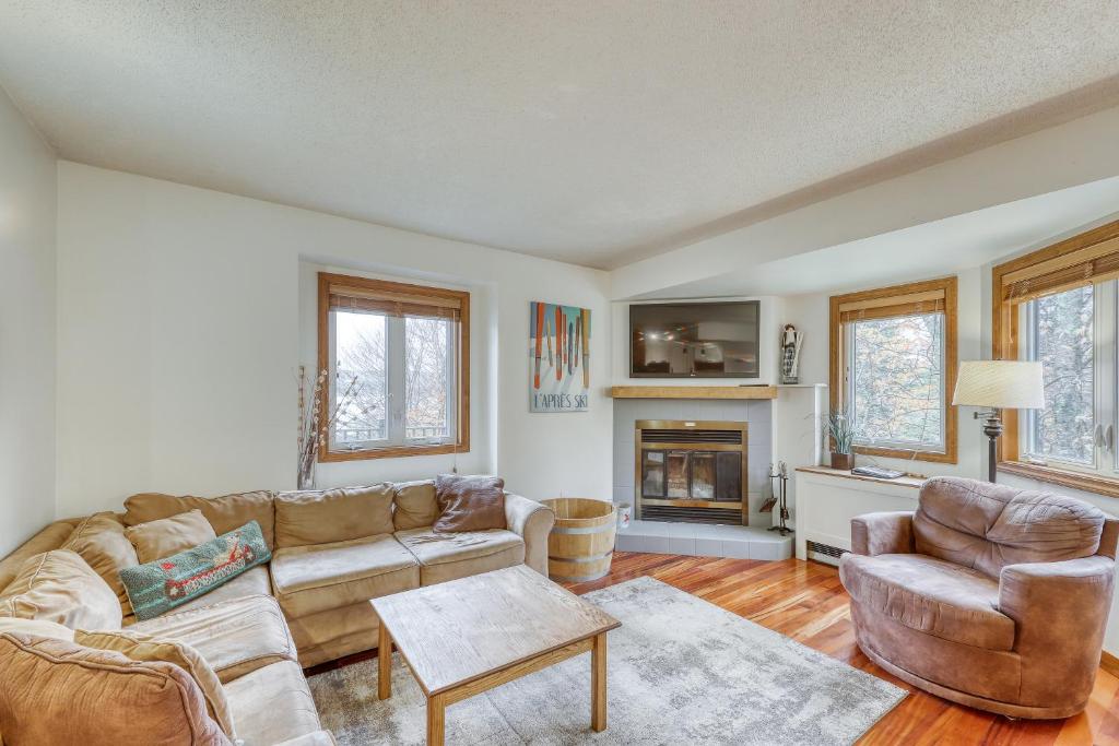 a living room with a couch and chairs and a fireplace at The Queens Slopeside Hideaway in Jay