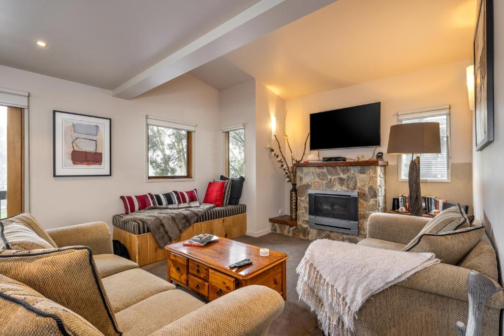 a living room with two couches and a fireplace at Alinga in Dinner Plain