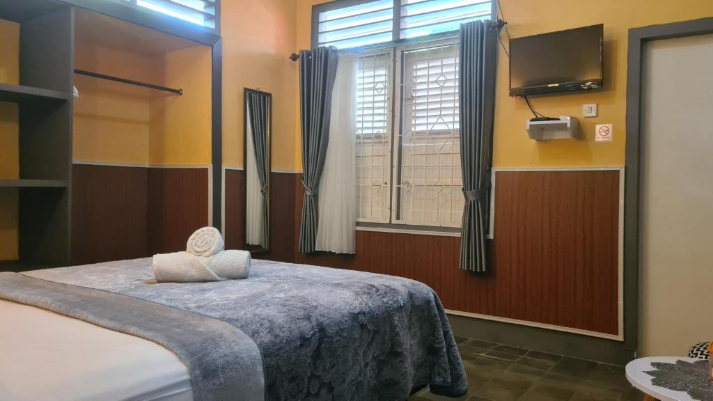 Postel nebo postele na pokoji v ubytování Dewi Sri Guesthouse