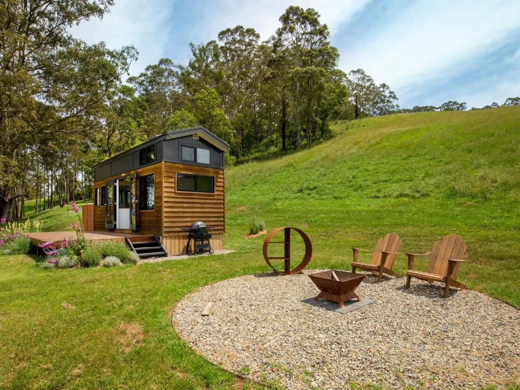 a tiny house sitting on top of a lush green hill at Stella at Kangaroo Valley - Amazing Views - Fire Pit in Barrengarry
