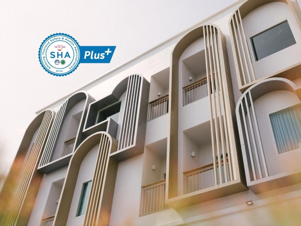 a rendering of the exterior of a building with the siu plus logo at Nappiness Hotel - SHA ExtraPlus in Bangkok