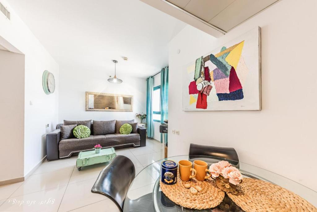 a living room with a table and chairs and a couch at Luxury Apartment on the Lake in Tiberias