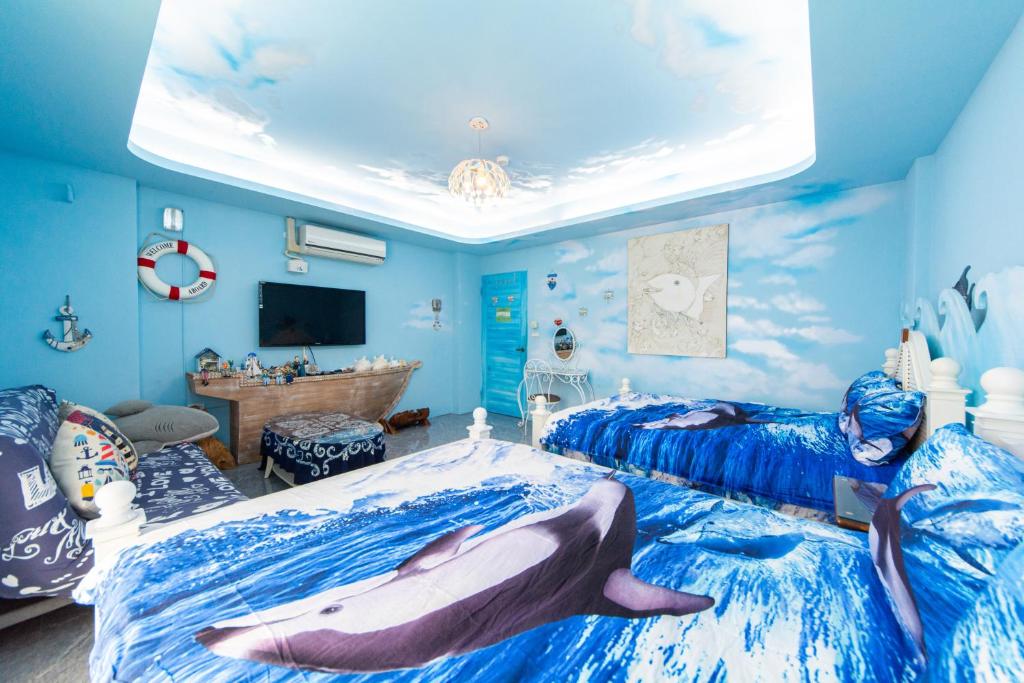 a bedroom with a shark on the bed at Sunflower B&B II in Hualien City
