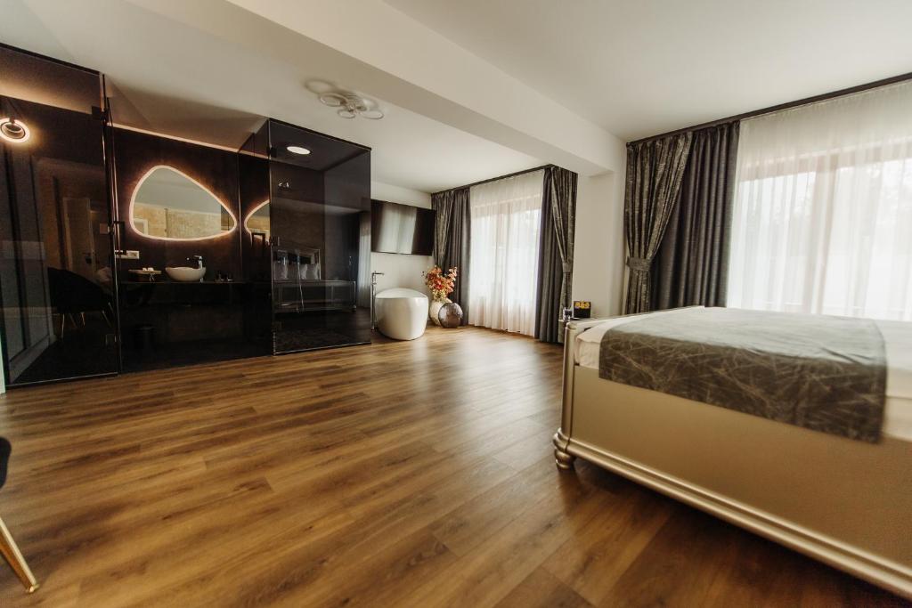 a bedroom with a bed and a bathroom at Boutique Damiani in Sibiu