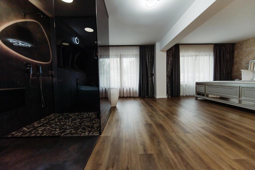 a large living room with a wooden floor and a mirror at Boutique Damiani in Sibiu