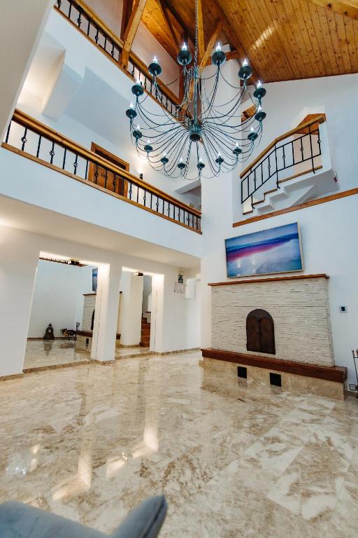 a large room with a chandelier and a fireplace at Boutique Damiani in Sibiu