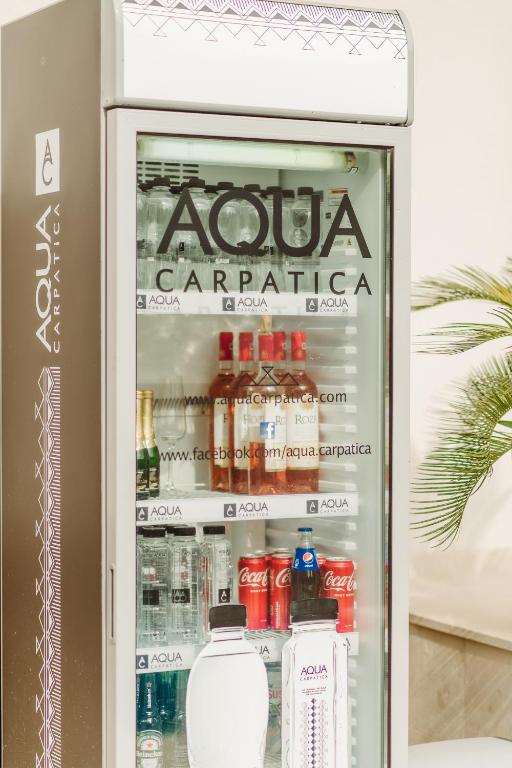 an open refrigerator filled with drinks and soda at Boutique Damiani in Sibiu
