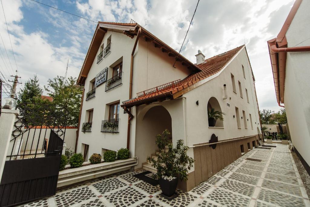 a building with a gate and a courtyard at Boutique Damiani in Sibiu