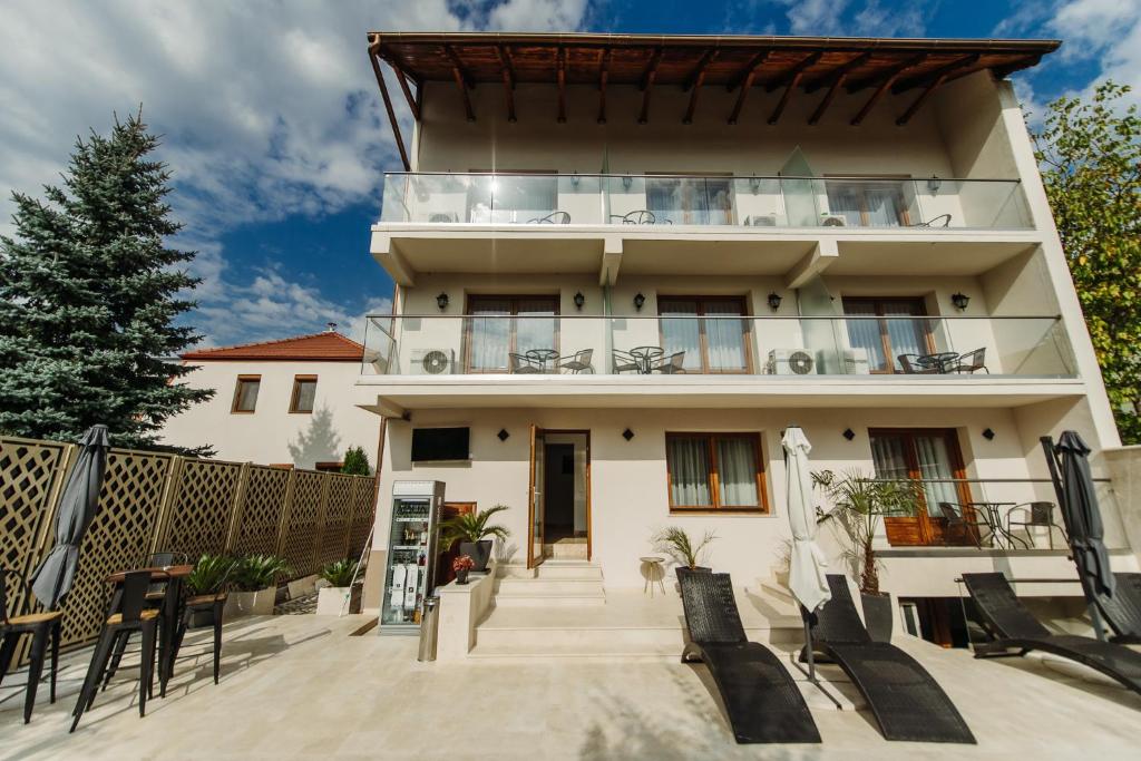 a large white building with a balcony at Boutique Damiani in Sibiu