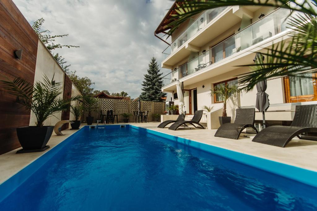 a swimming pool in the backyard of a house at Boutique Damiani in Sibiu