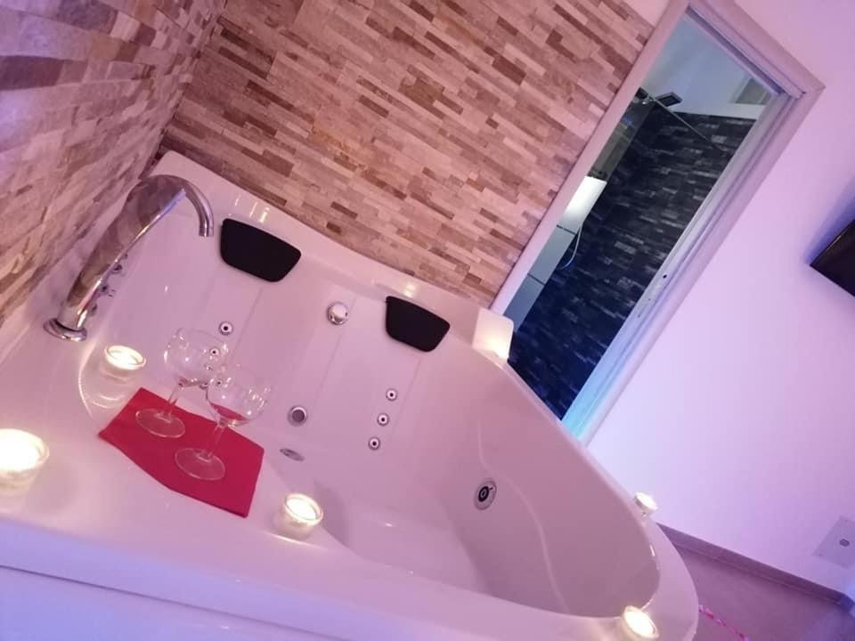 a white bath tub with wine glasses in it at B&B La Perla & Suites in Bari