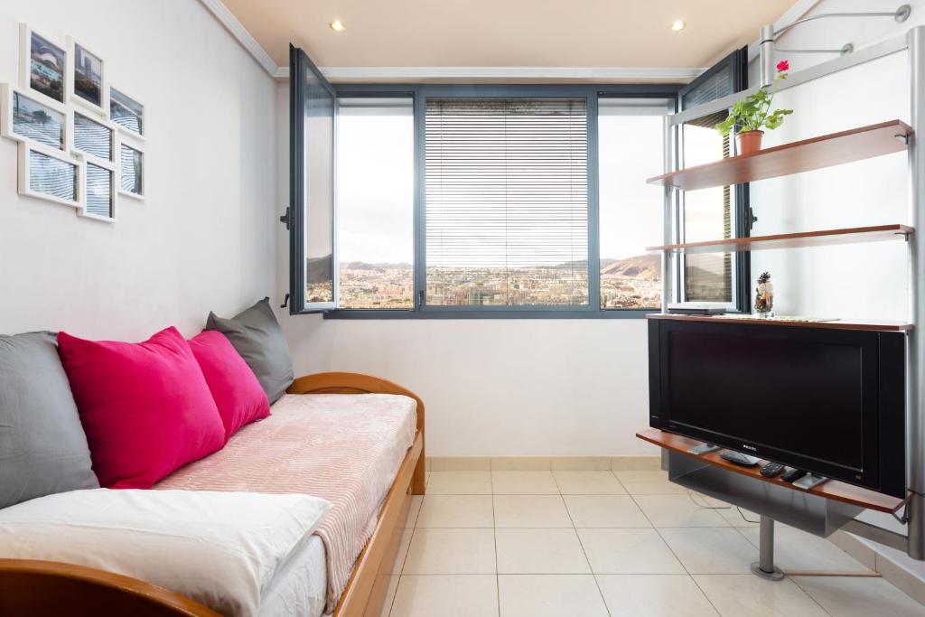 a living room with a couch and a flat screen tv at Home2Book Amazing View Apart Floor 25 Santa Cruz in Santa Cruz de Tenerife