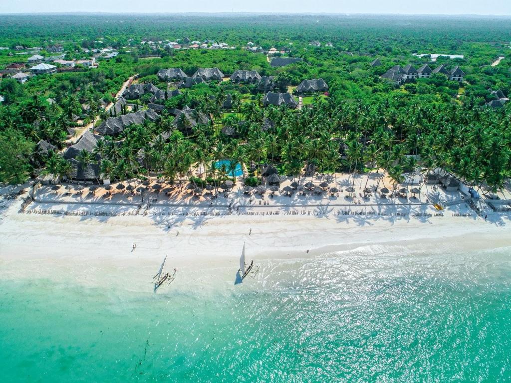 an aerial view of a beach with people in the water at Veraclub Zanzibar Village in Kiwengwa