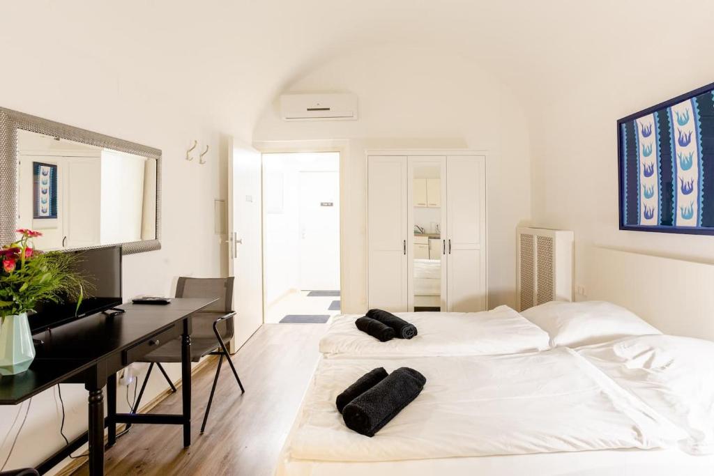 ウィーンにあるAir Condition I all sights in walking distance I 201 Mbit Wifiのベッド2台、デスク、ピアノが備わる客室です。