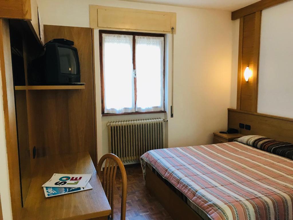 Postel nebo postele na pokoji v ubytování Hotel Santoni