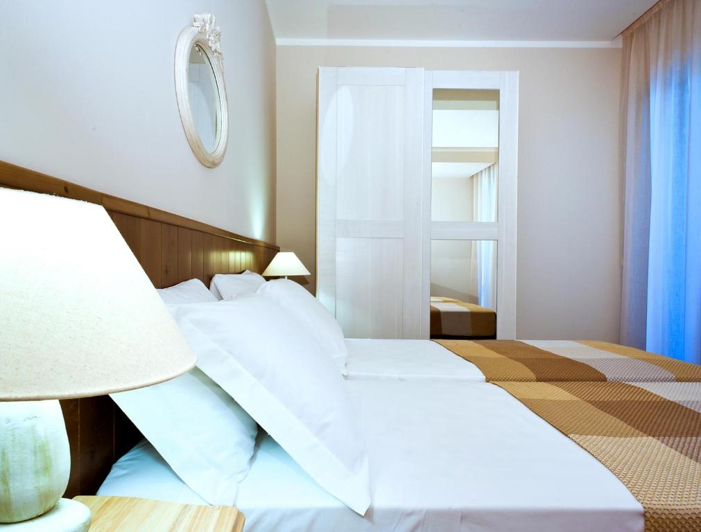 Postel nebo postele na pokoji v ubytování Hotel Ambassador