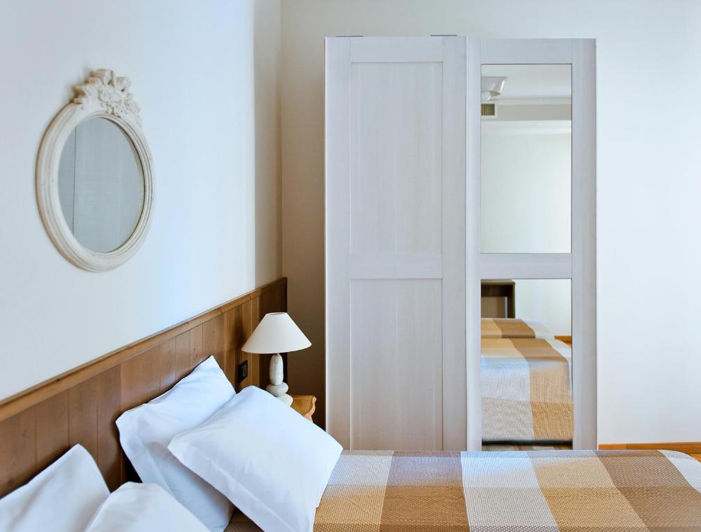 Postel nebo postele na pokoji v ubytování Hotel Ambassador