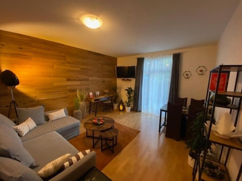 a living room with a white couch and a wooden wall at "Erfurt genießen" in Erfurt