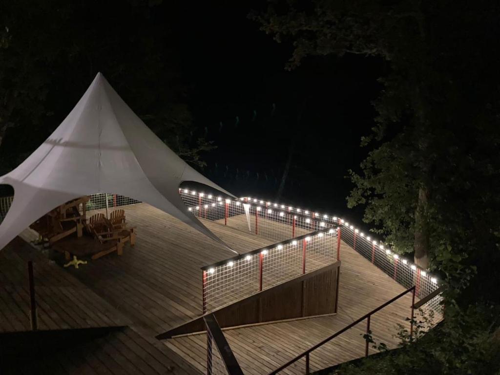 a string of lights on a deck at night at MIUSSERA SEA GLAMPING in Gudauta