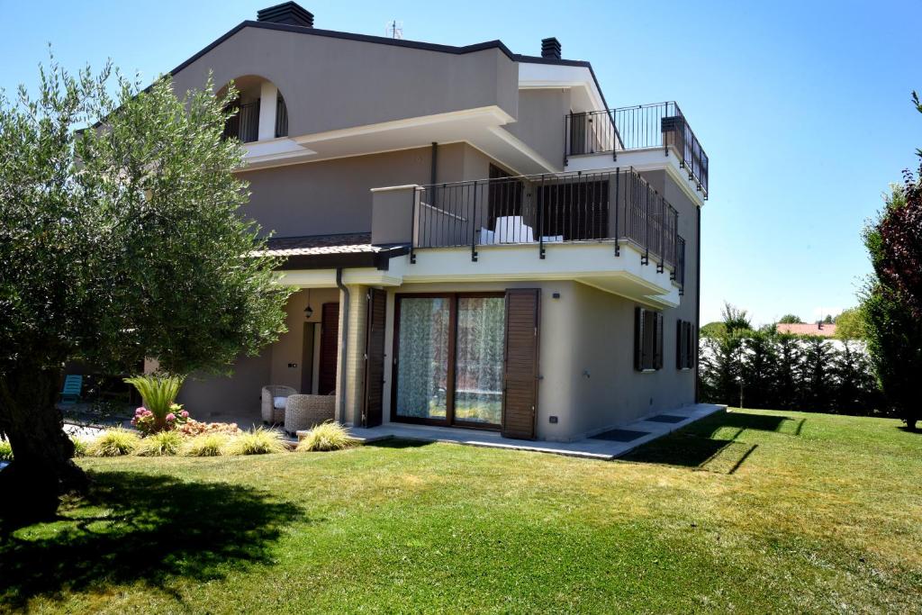 a large white house with a yard at Villa al Mare in Bellaria-Igea Marina
