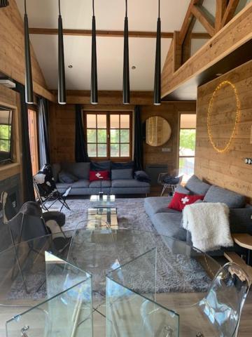 a living room with a couch and a glass table at CHALET MONT BLANC in Combloux