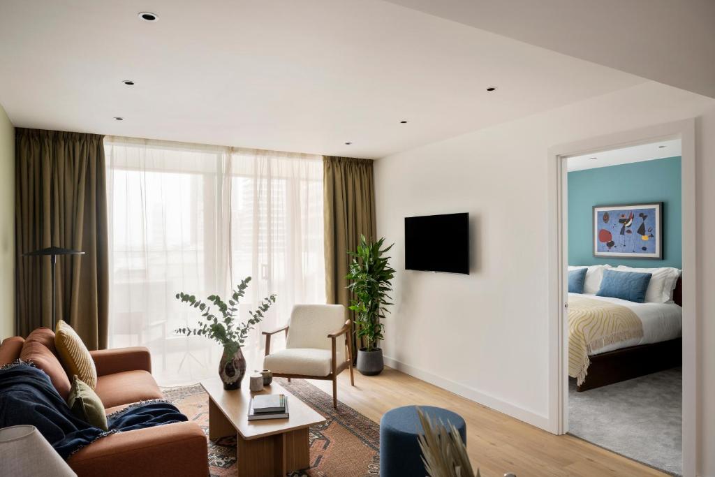 a living room with a couch and a bed at Cove Landmark Pinnacle in London