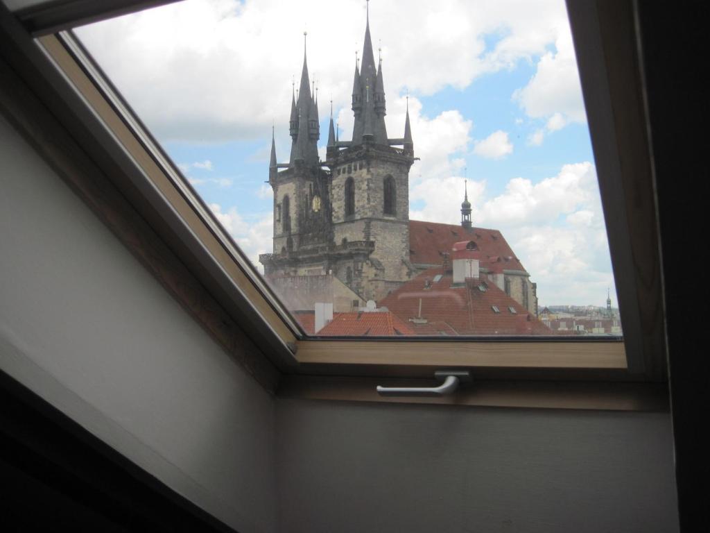 a window in a room with a view of a church at Apartmány Železná in Prague