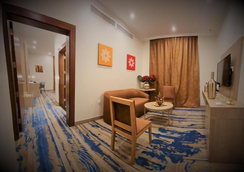 Televiisor ja/või meelelahutuskeskus majutusasutuses Signature Guest Hotel فندق إمضاء النزيل الفندقية