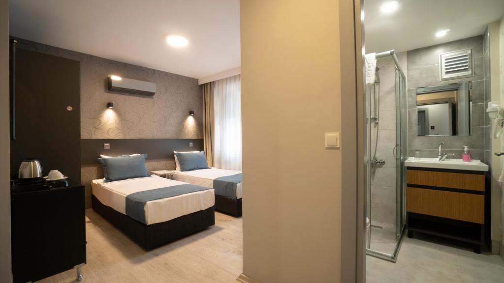 A bed or beds in a room at OPERA Hotel Antalya