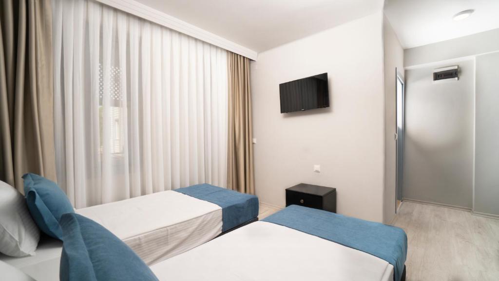 A bed or beds in a room at OPERA Hotel Antalya