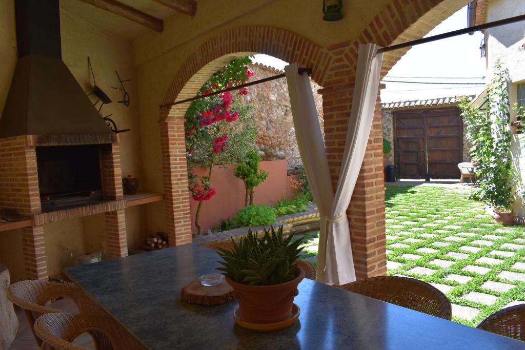 Habitación con mesa y patio con jardín. en La Casa del Azafrán, en Villanueva del Rebollar de la Sierra